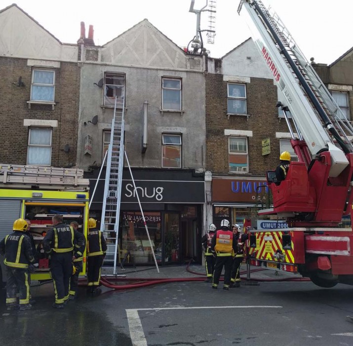 Woman arrested after rescue from burning flat in north London