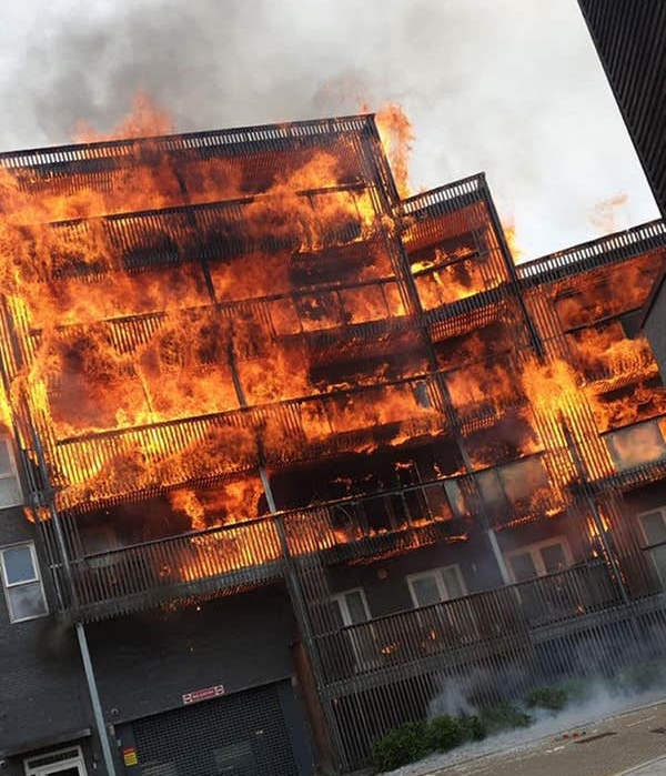Blazing fire engulfs a block of flats