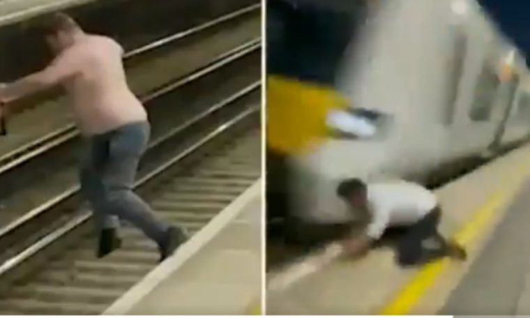 Raylara atlayan adam, saliselerle trenin altında kalmaktan kurtuldu
